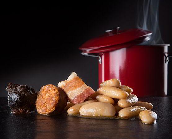 Still life of abada. Beans and compango in the foreground with the squid behind.