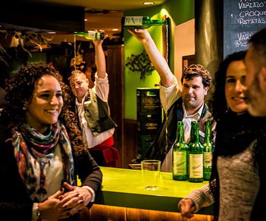 Image of a group of friends in a cider house drinking cider.